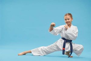 young black belt martial arts student dressed in gi displaying a defensive pose