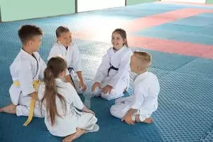 group of children in various ages dressed in gi enjoying their time together