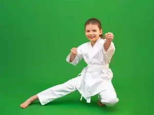 aa white belt martial arts student posing in gi